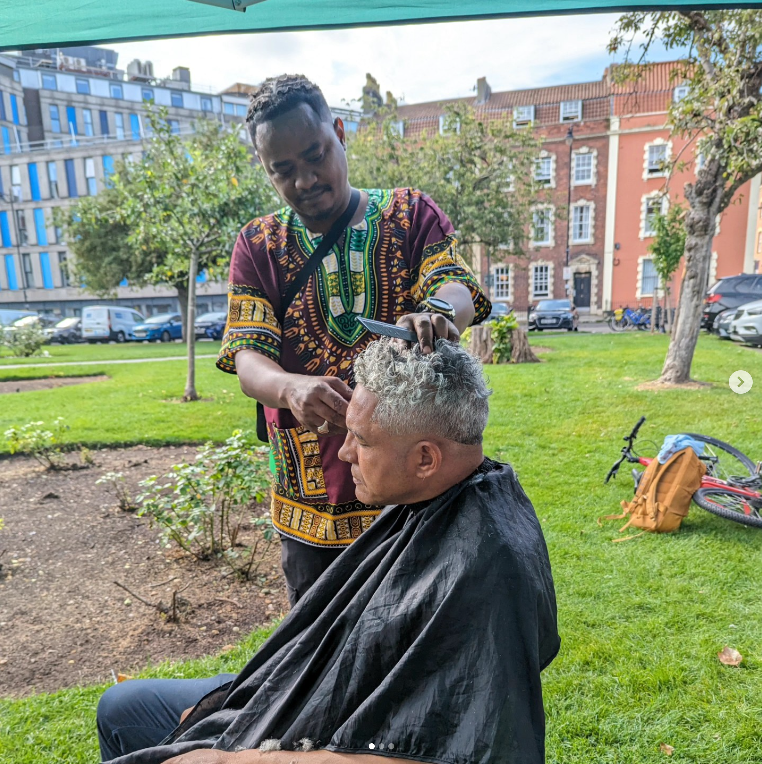 Eddie mid-cut, talking with a client on the street